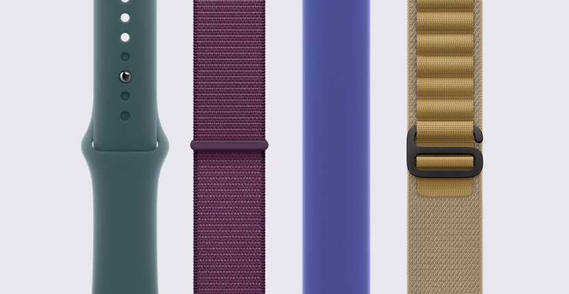 Quatre bracelets d’Apple Watch différents placés à la verticale l’un à côté de l’autre.