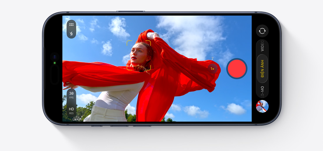 Screen showing Cinematic Mode capturing person dancing outside with flowing red scarf