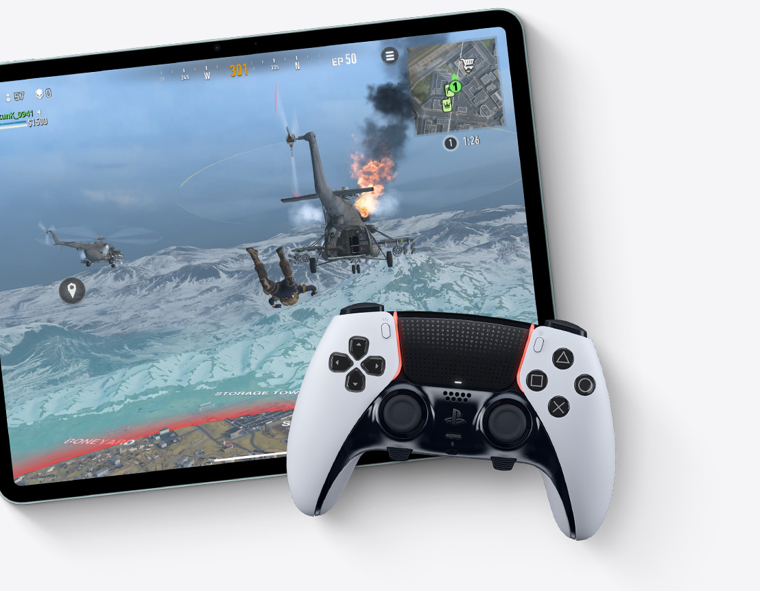An iPad Air showcasing "Call of Duty: Warzone" game with an external controller sitting on top of it.